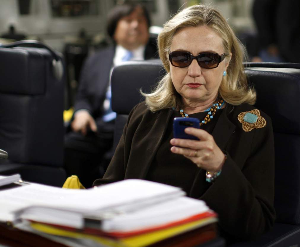 Former U.S. Secretary of State Hillary Clinton checks her PDA upon her departure in a military C-17 plane from Malta bound for Tripoli, Libya, in this October 18, 2011, file photo. An investigative committee in the U.S. House of Representatives will subpoena Clinton's personal emails regarding the 2012 attack on the U.S. consulate in Benghazi, Libya, the Washington Post reported on March 4, 2015. 
REUTERS/Kevin Lamarque/Files  (LIBYA - Tags: POLITICS)